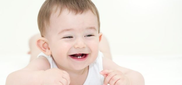 smiling baby with a couple of teeth showing